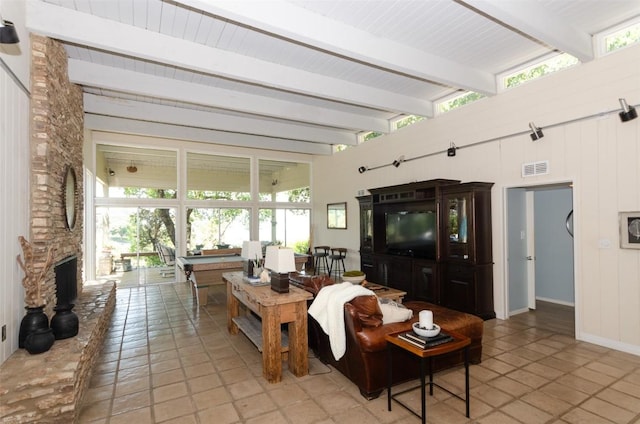 tiled living room featuring beamed ceiling, a fireplace, and billiards