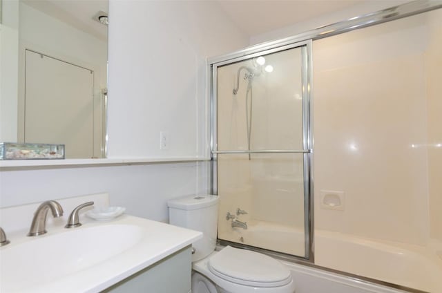 full bathroom with vanity, toilet, and shower / bath combination with glass door