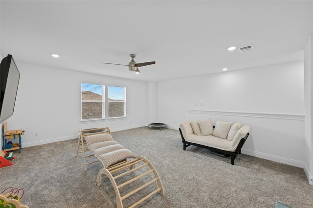 living area featuring ceiling fan and light carpet