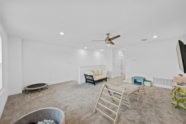 living room featuring light carpet and ceiling fan