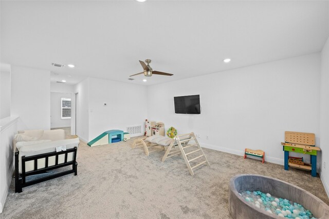 rec room with carpet and ceiling fan