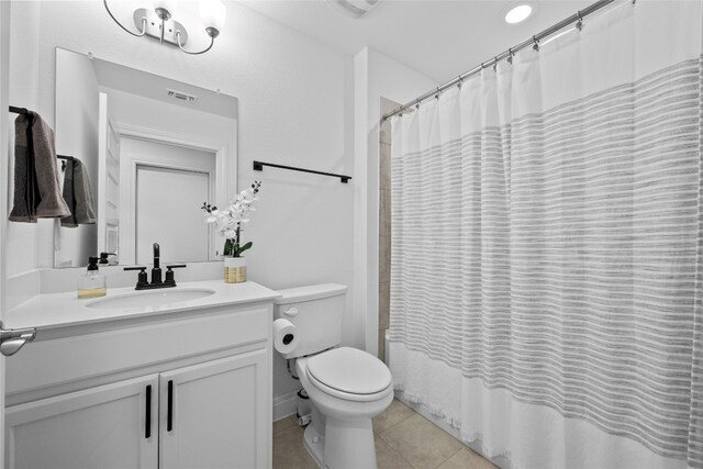 full bathroom featuring vanity, toilet, tile patterned flooring, and shower / bath combo