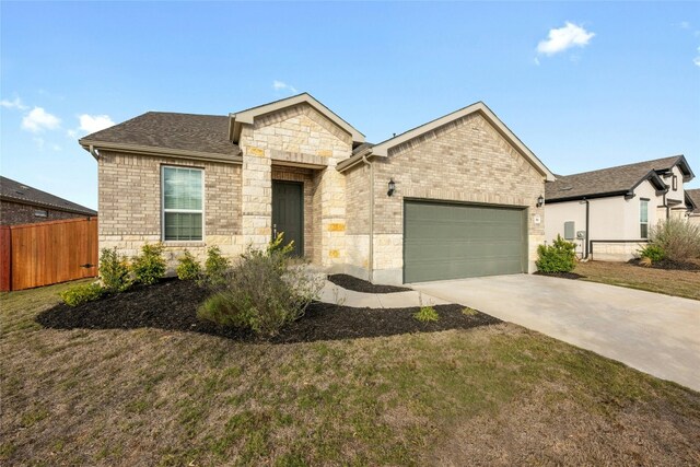 view of front of home featuring a front yard and a garage