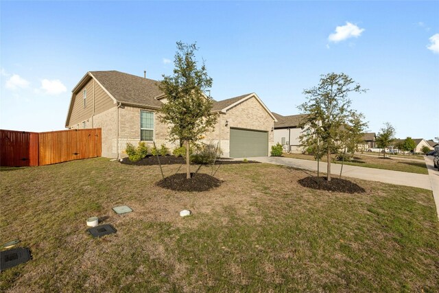 view of front of house with a front yard and a garage