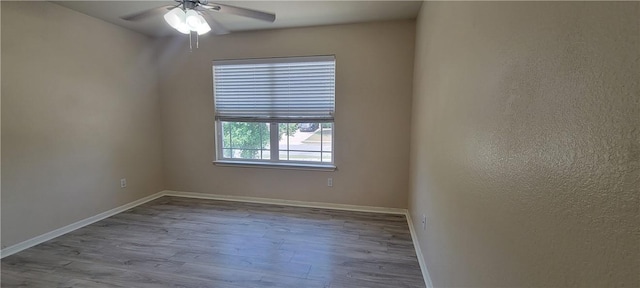 unfurnished room featuring ceiling fan and light hardwood / wood-style floors