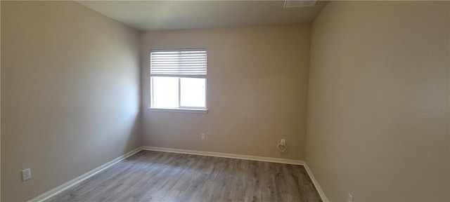 spare room with light hardwood / wood-style flooring