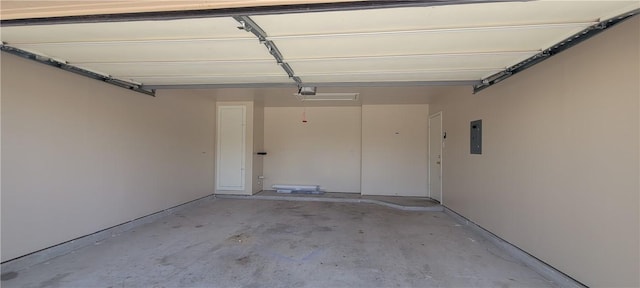 garage featuring electric panel and a garage door opener