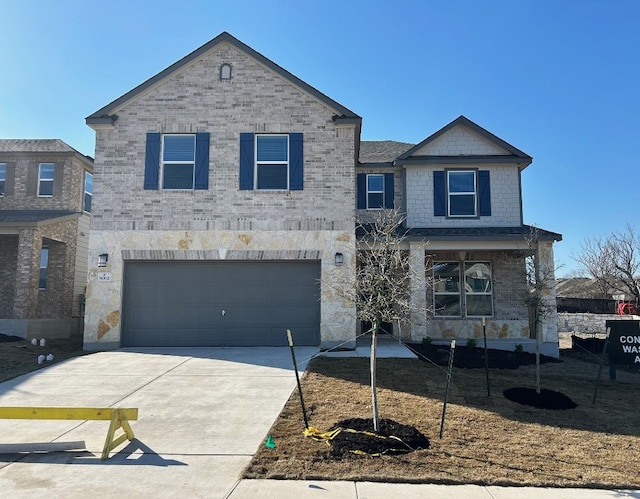 view of front of property featuring concrete driveway, brick siding, and an attached garage