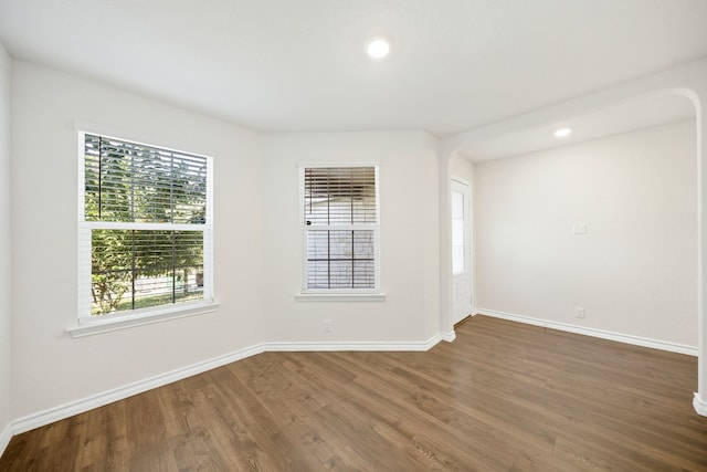 spare room featuring dark hardwood / wood-style flooring