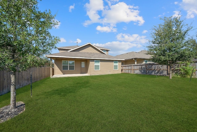 back of property featuring a lawn and a patio area