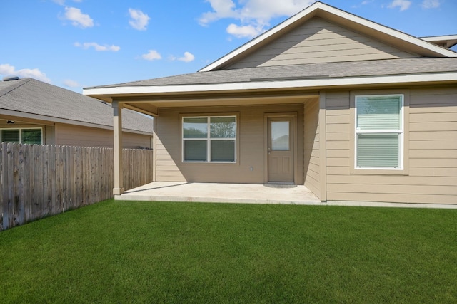 back of property featuring a yard and a patio