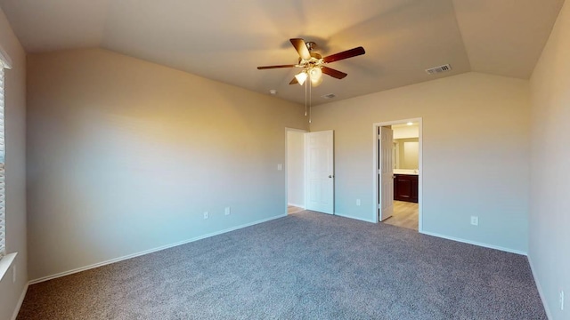 unfurnished bedroom with ceiling fan, light colored carpet, connected bathroom, and vaulted ceiling