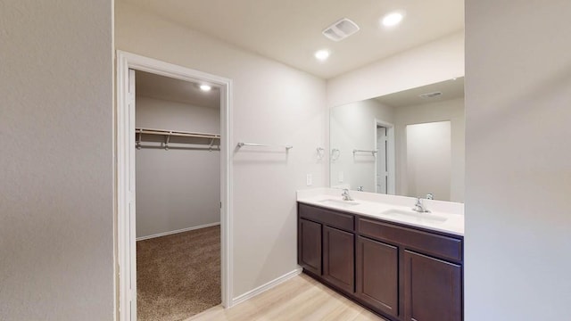 bathroom with vanity and hardwood / wood-style flooring