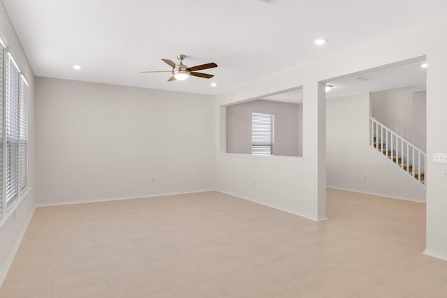 unfurnished room with recessed lighting, stairway, baseboards, and a ceiling fan