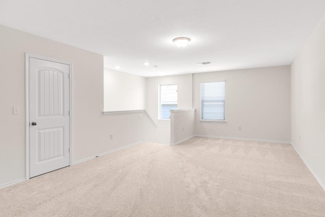 unfurnished room featuring carpet flooring and baseboards