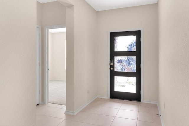 foyer entrance featuring tile patterned flooring and baseboards