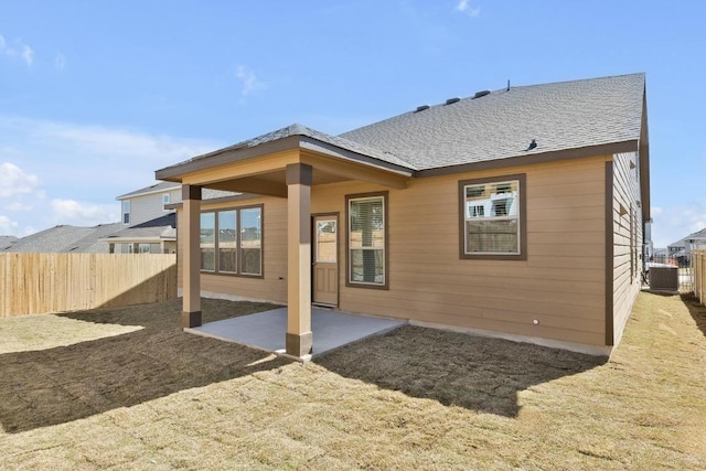 back of house featuring a patio area, roof with shingles, central AC, and fence