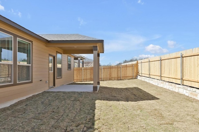 view of yard featuring a patio area and a fenced backyard