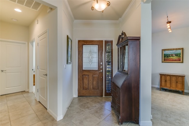 foyer featuring ornamental molding and light tile patterned flooring