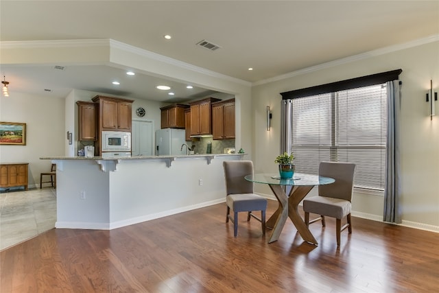 dining room featuring crown molding and hardwood / wood-style floors