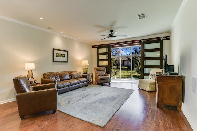 living room with dark hardwood / wood-style floors, ceiling fan, and ornamental molding