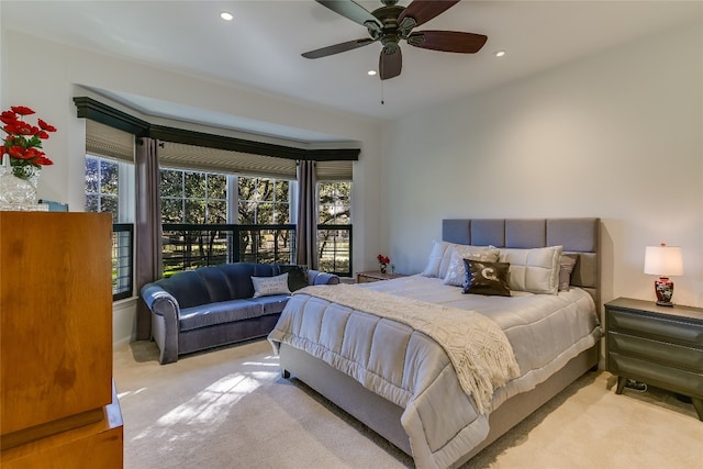 bedroom featuring ceiling fan and light carpet