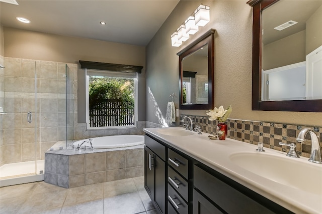 bathroom featuring tile patterned floors, vanity, and shower with separate bathtub