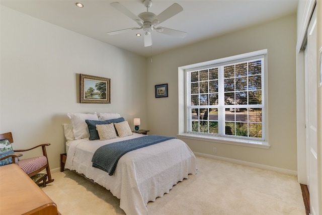 bedroom featuring ceiling fan and light colored carpet