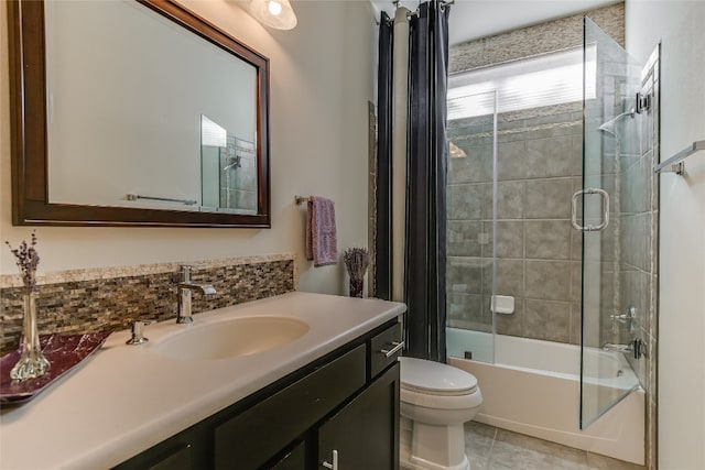 full bathroom featuring tile patterned floors, vanity, toilet, and tiled shower / bath