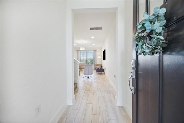 hallway with light hardwood / wood-style flooring