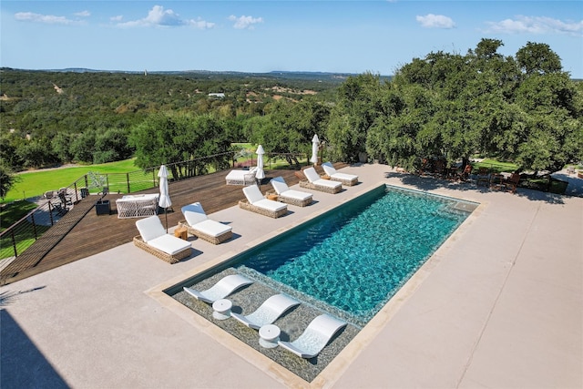 view of pool with a patio and a deck