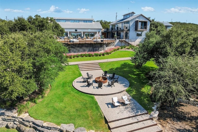 exterior space featuring a fire pit, a patio area, and a lawn