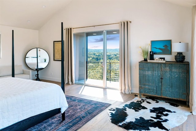 bedroom featuring access to exterior, light hardwood / wood-style floors, and lofted ceiling