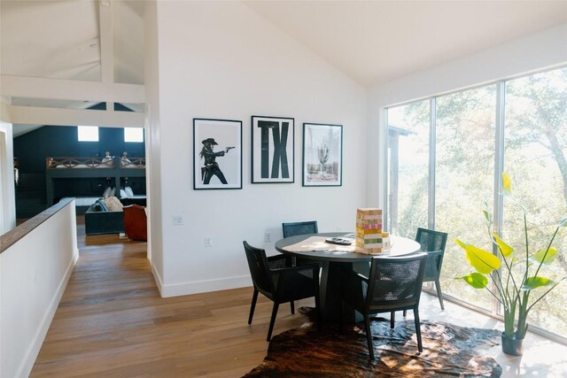 dining area featuring lofted ceiling and hardwood / wood-style flooring