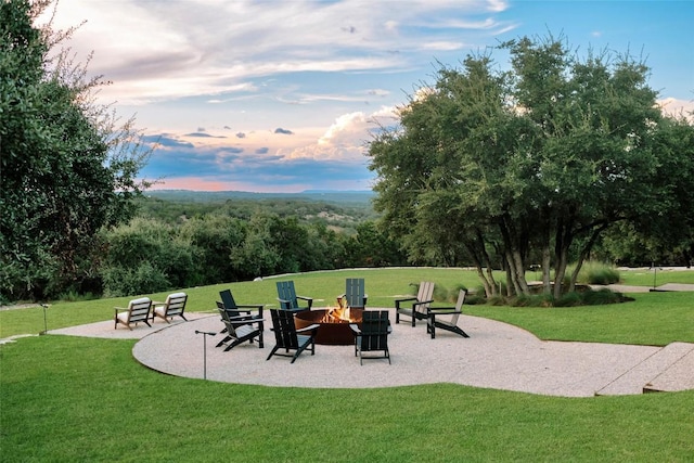 surrounding community featuring a lawn, an outdoor fire pit, and a patio