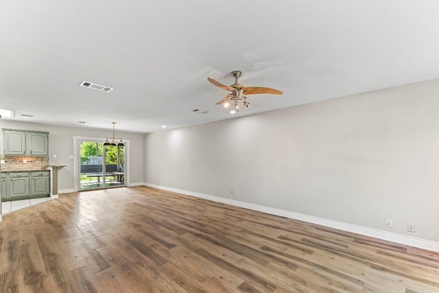 1807 Iris Ln, Cedar Park, TX 78613 - unfurnished living room with baseboards, wood finished floors, and a ceiling fan