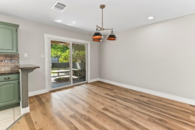 1807 Iris Ln, Cedar Park, TX 78613 - unfurnished dining area featuring baseboards, light wood finished floors, and recessed lighting