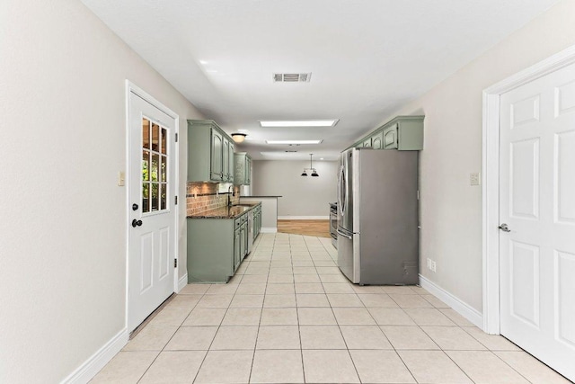 1807 Iris Ln, Cedar Park, TX 78613 - kitchen featuring green cabinets, freestanding refrigerator, a sink, and dark countertops