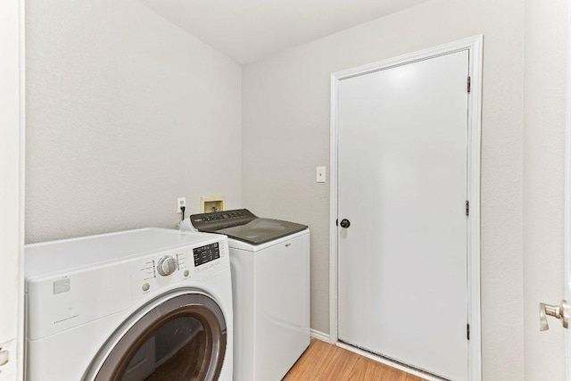 1807 Iris Ln, Cedar Park, TX 78613 - laundry area featuring separate washer and dryer and light wood-style floors