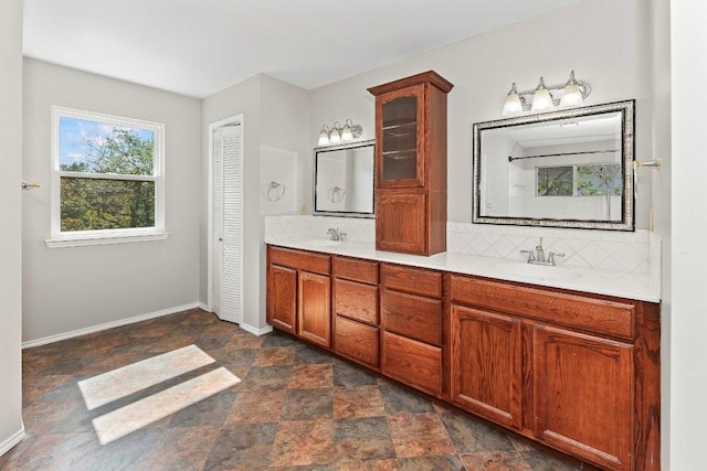 1807 Iris Ln, Cedar Park, TX 78613 - bathroom with stone finish floors, double vanity, backsplash, and baseboards