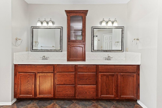 1807 Iris Ln, Cedar Park, TX 78613 - bathroom featuring decorative backsplash, double vanity, and baseboards