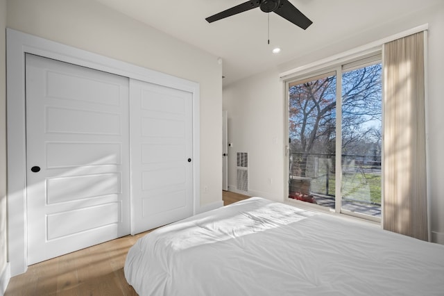 bedroom featuring ceiling fan, access to exterior, wood-type flooring, and a closet