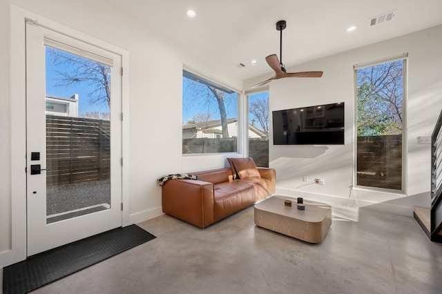 living room with ceiling fan and a healthy amount of sunlight