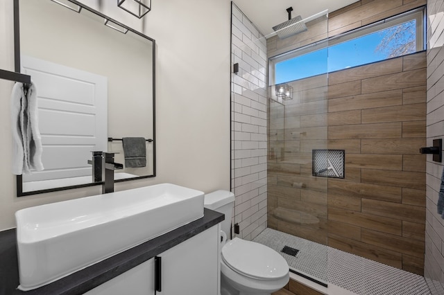 409 W Odell St Unit 2, Austin, TX 78752 - bathroom featuring tiled shower, vanity, and toilet