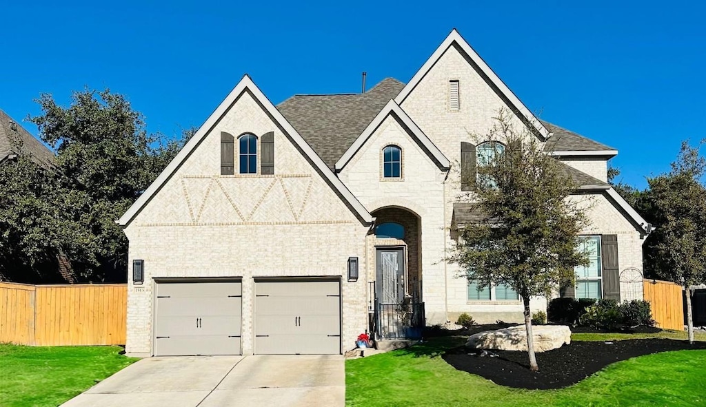 view of front of home with a garage and a front lawn