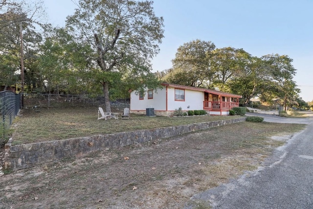 view of front facade with cooling unit and fence