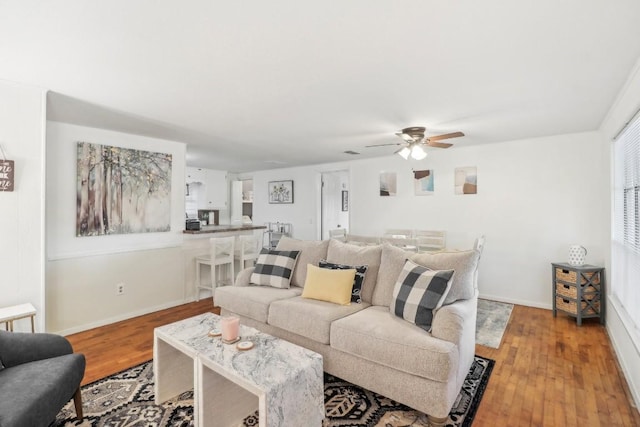 living room with ceiling fan and light wood-type flooring