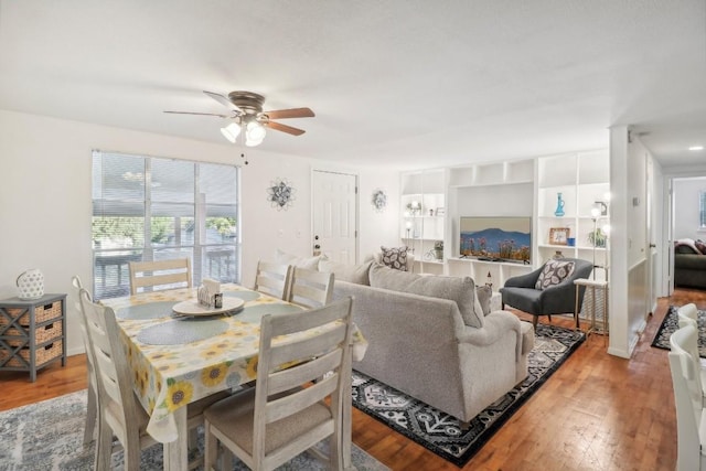 dining area with light wood-style flooring and ceiling fan