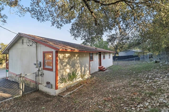 rear view of property featuring fence