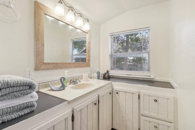 bathroom with vanity and lofted ceiling